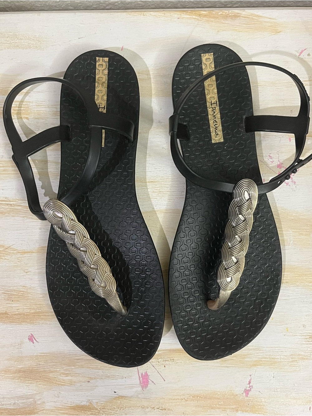 Ipanema Black Sandals with Braided Gold T-Strap Accent